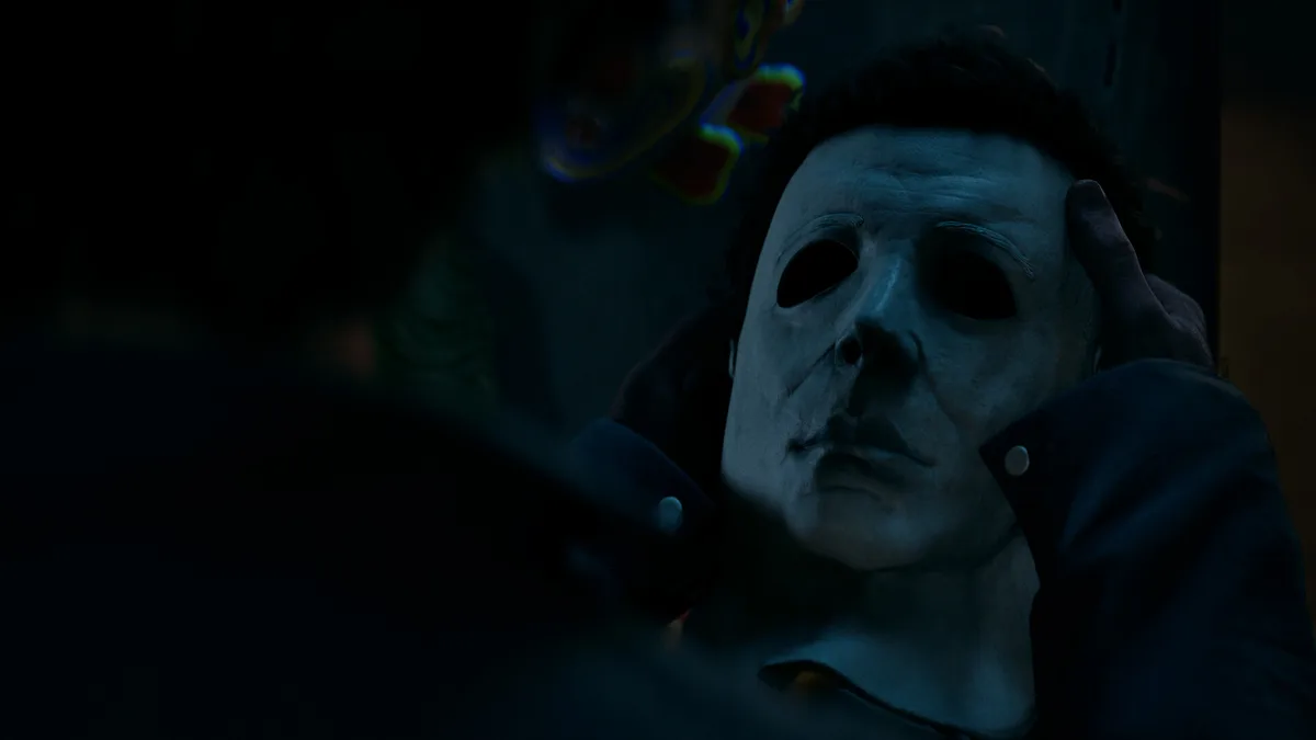 Close-up of Michael Myers mask in darkness in Halloween The Game